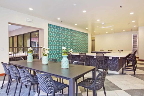 A dining room with a long table and chairs.
