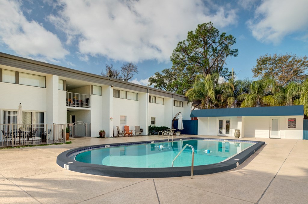 the pool area of a hotel with a swimming pool