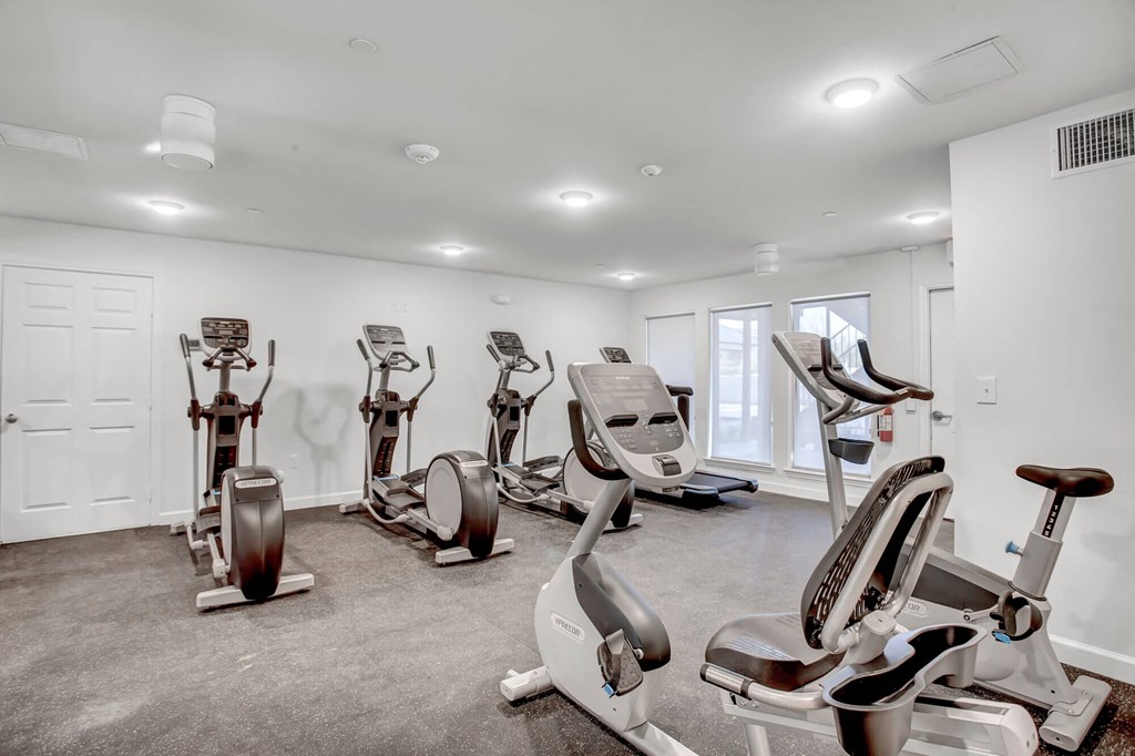 the gym with treadmills and elliptical machines