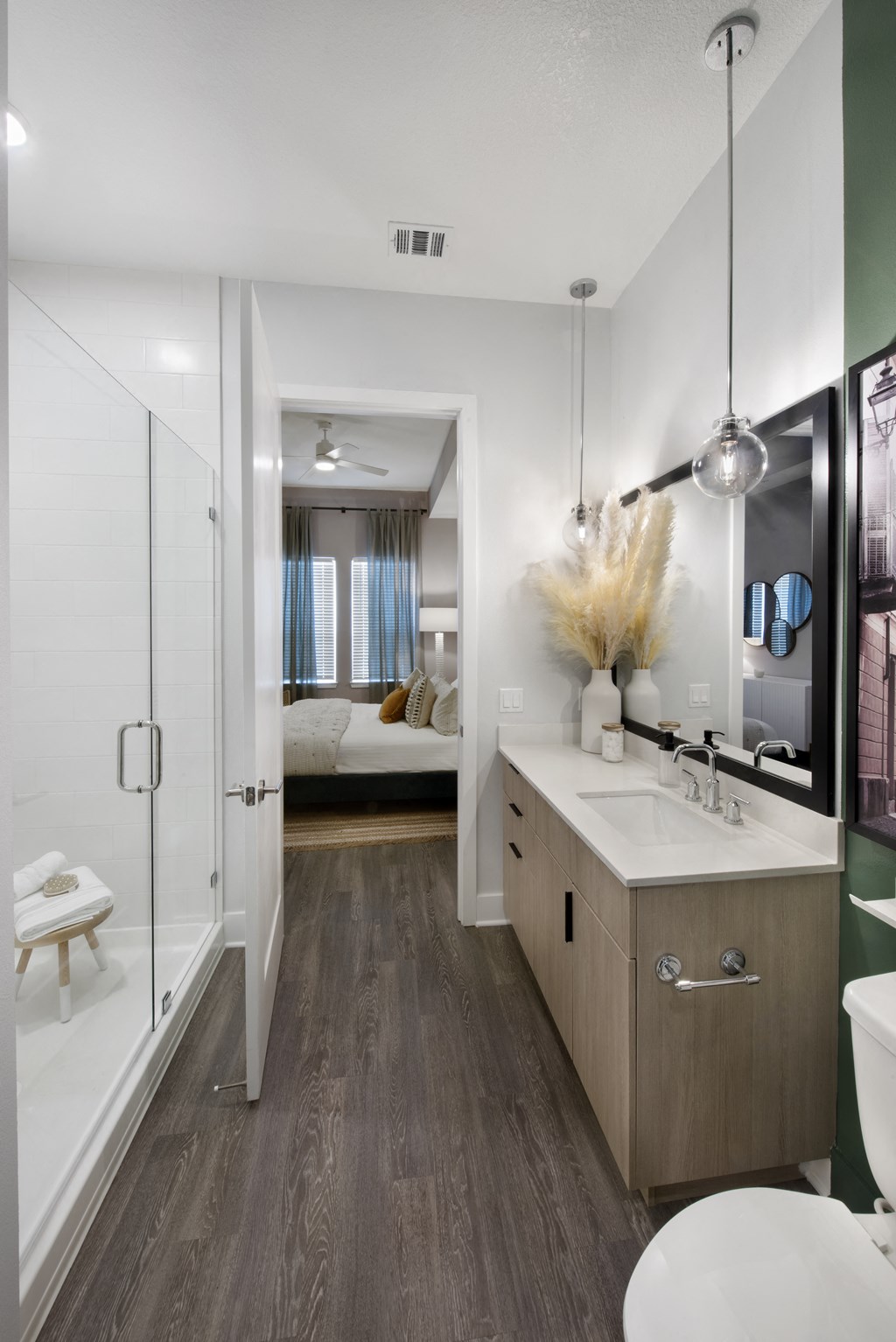 a bathroom with a shower and a sink and a mirror