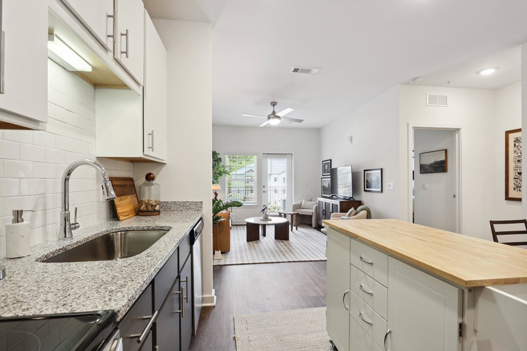 a kitchen and living room with a view of a living room and dining room