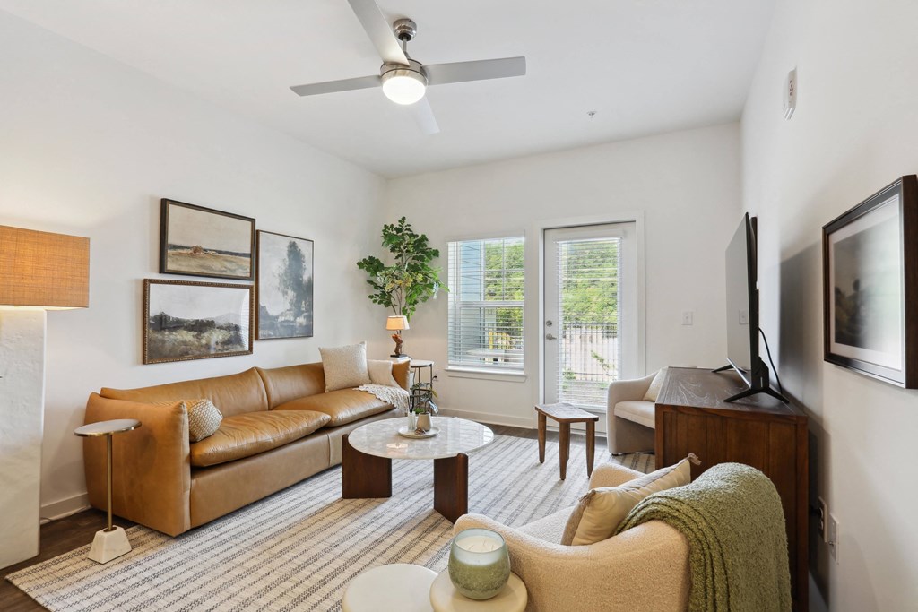 a living room with white walls and a striped rug