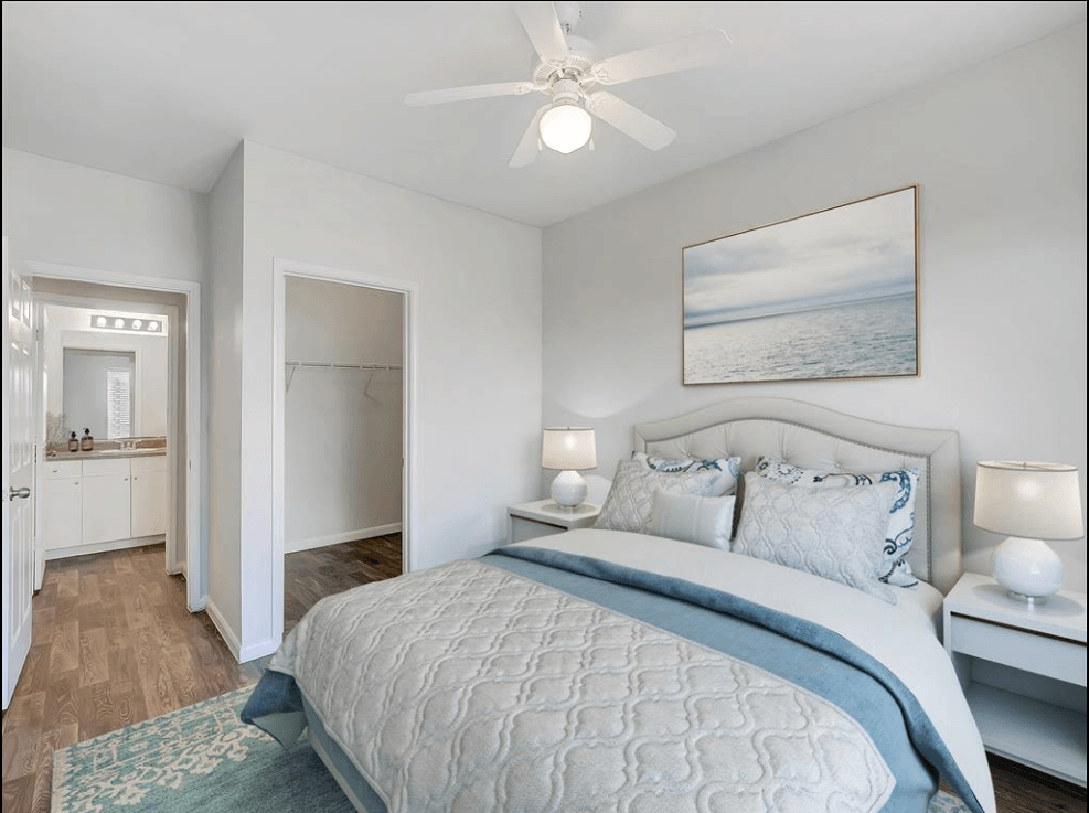 a bedroom with a bed and a ceiling fan