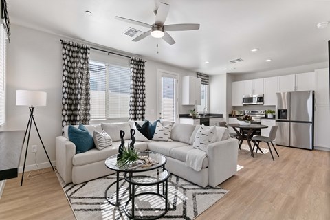 A modern living room with a white couch and a black coffee table.