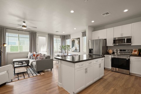 A modern kitchen with white cabinets and a large island.