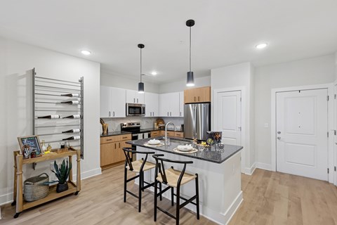 A kitchen with a table and chairs in the middle of it.