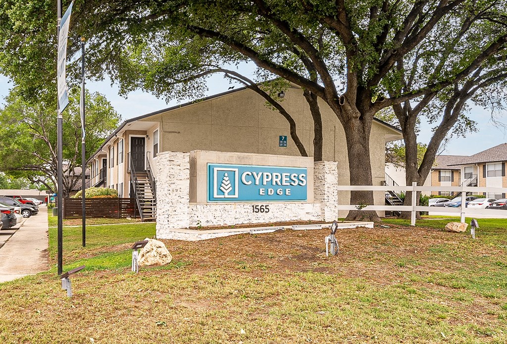 a sign that says cypress edge in front of a building