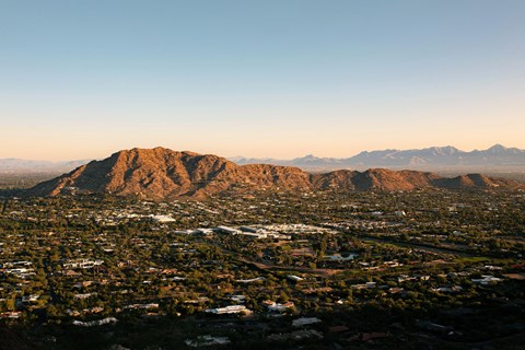 A cityscape with a mountain in the background.