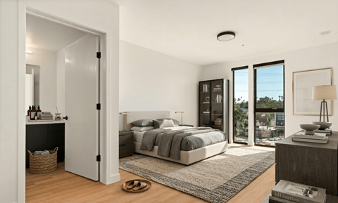 A modern bedroom with a large bed and a view of the city.