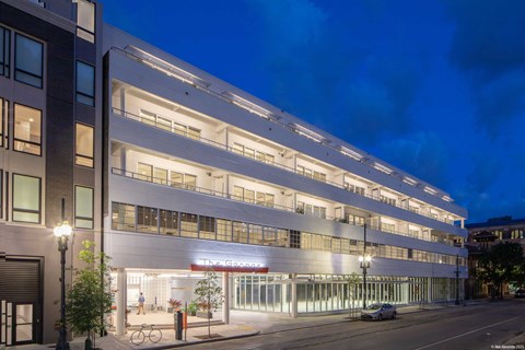 A modern building with a bicycle parked in front.