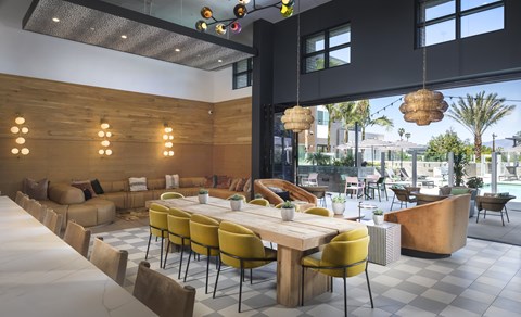 A modern dining area with yellow chairs and wooden tables.