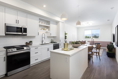 A modern kitchen with white cabinets and a large island.