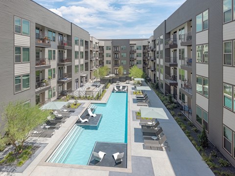 an aerial view of an apartment complex with a large swimming pool