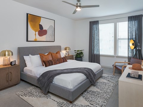 a bedroom with a bed and a chair in a room