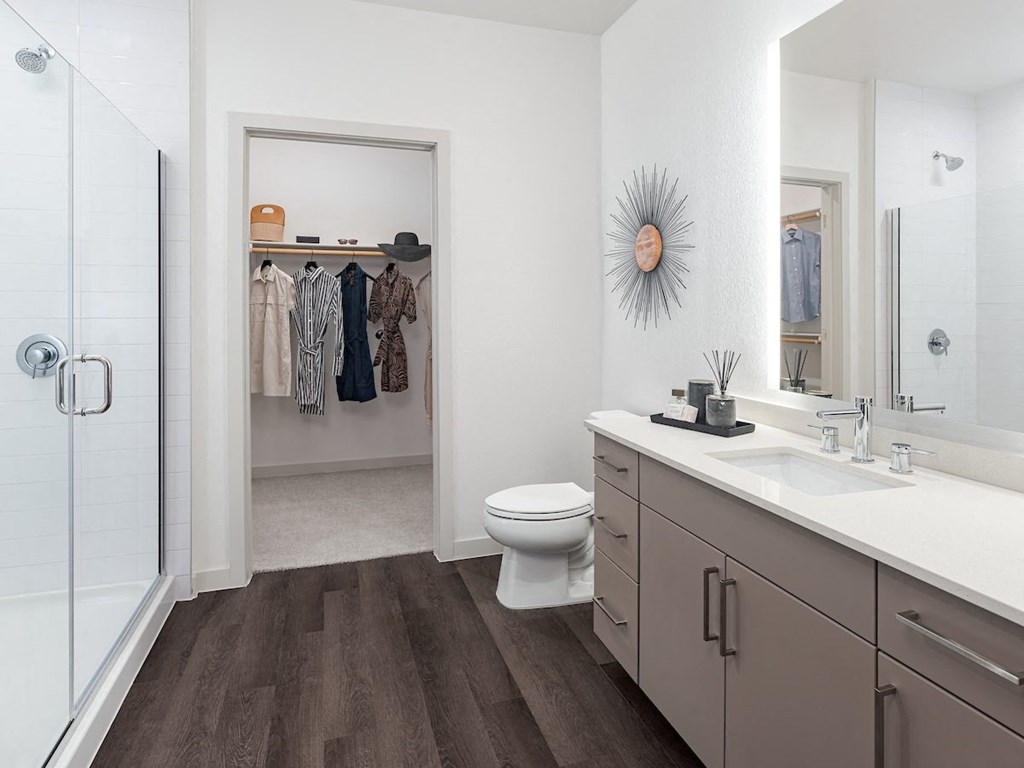 a bathroom with a toilet sink and shower in a 555 waverly unit