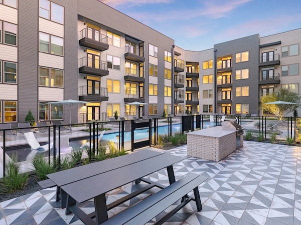 a rendering of an apartment complex with a swimming pool and picnic table