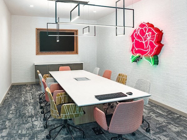 a conference room with a large red flower on the wall
