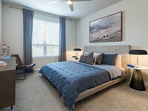 a bedroom with a bed and a desk with a chair