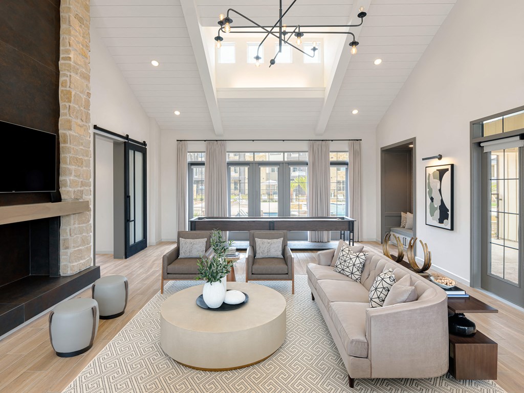 A modern living room with a fireplace and a large couch.