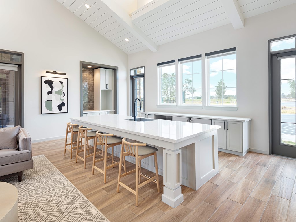 A kitchen with a bar area and a couch.