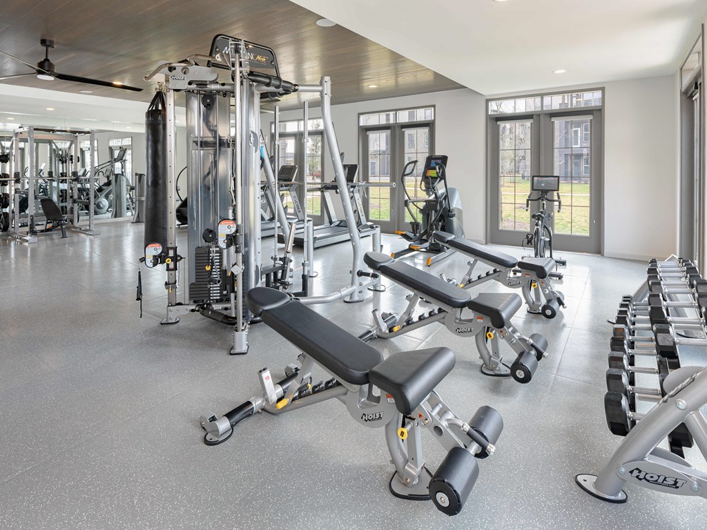 A spacious gym with a variety of equipment including treadmills, weights, and exercise machines.