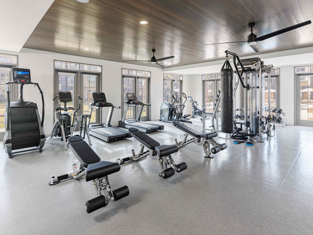 A spacious gym with a variety of equipment including treadmills, exercise bikes, and weight machines.