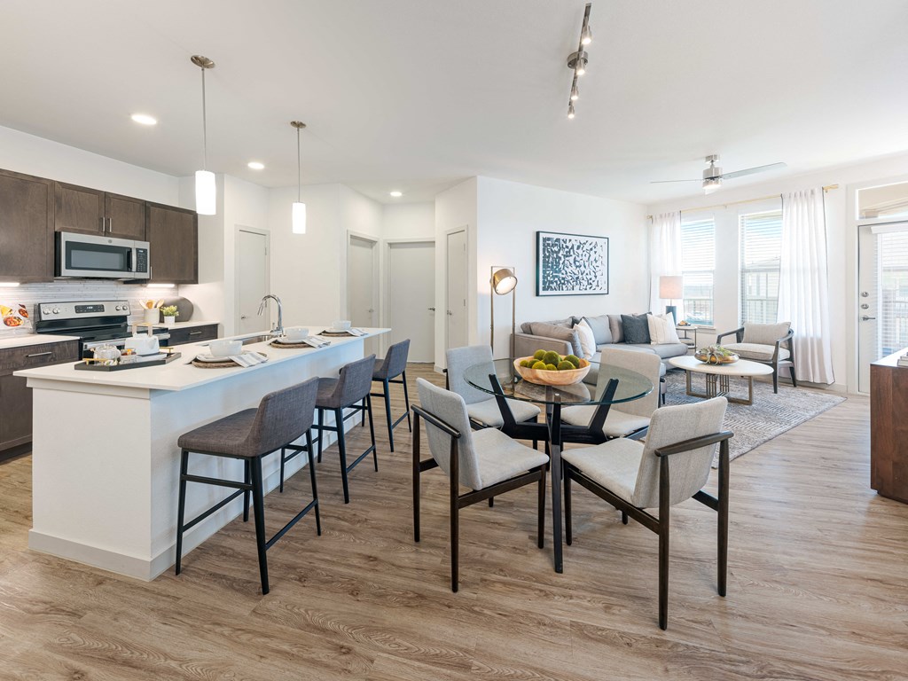 A modern kitchen with a dining table and chairs.