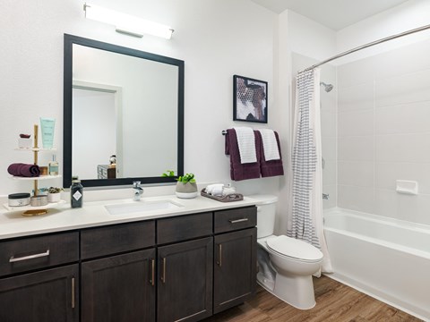 A bathroom with a white sink and a white toilet.