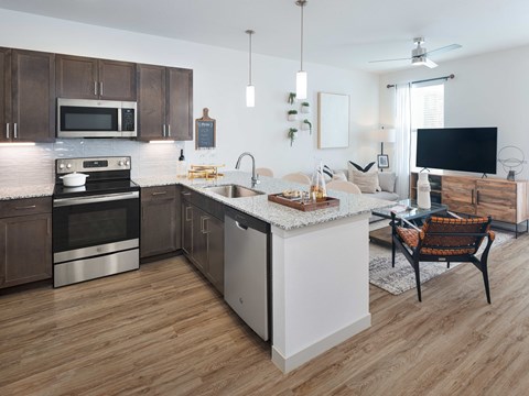 A modern kitchen with wooden cabinets and a white island.