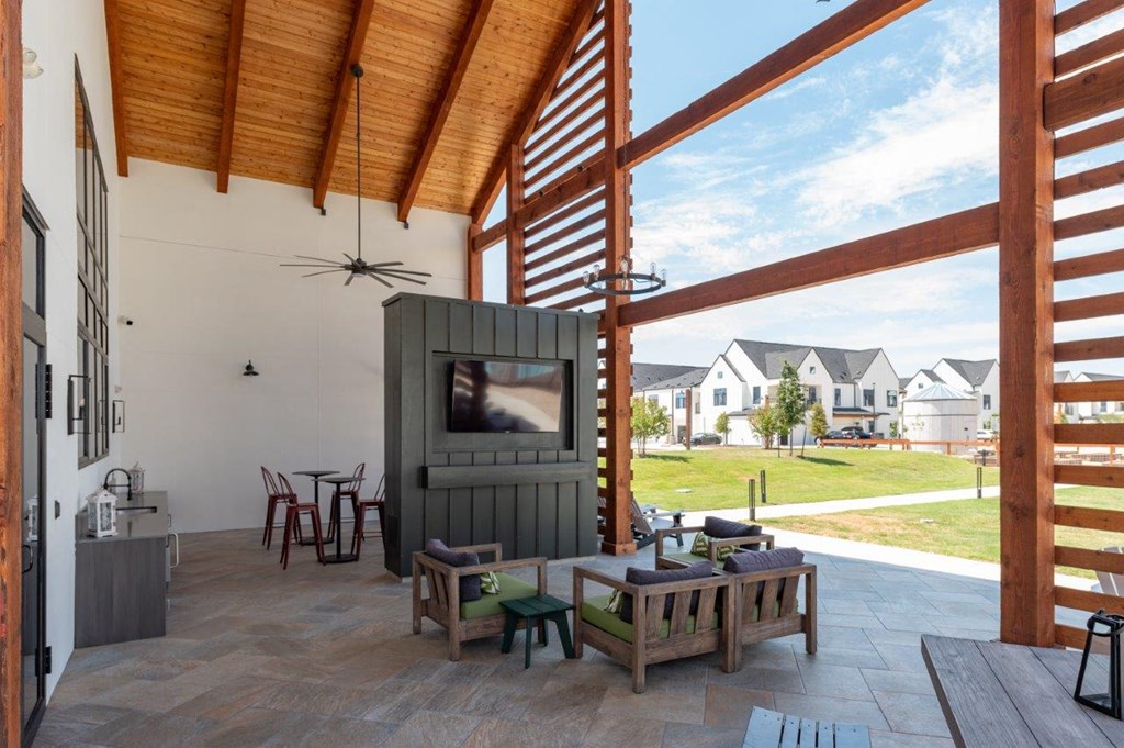 a living room with a tv and a patio
