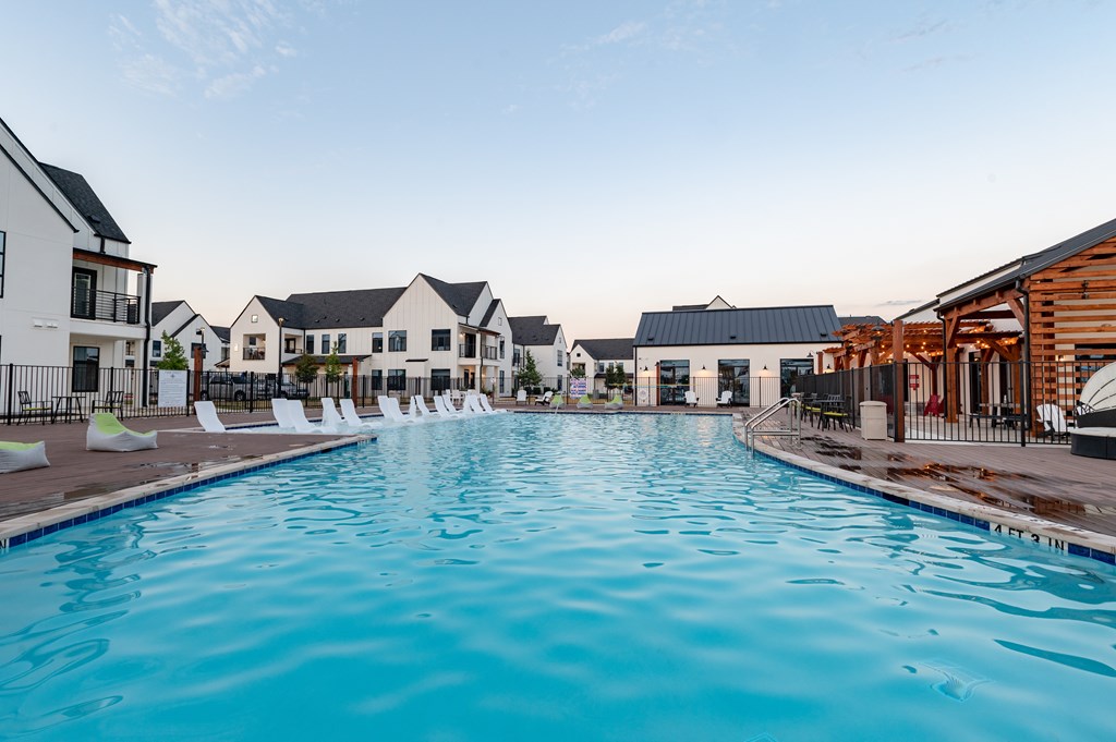 A large swimming pool in front of a resort.