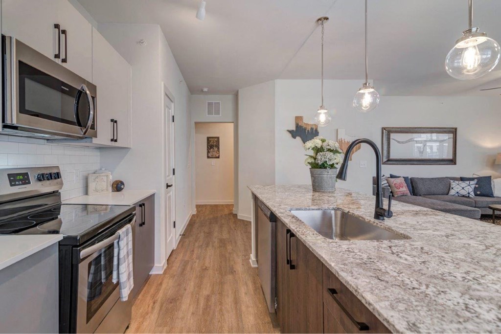 a kitchen with a marble counter top and a sink