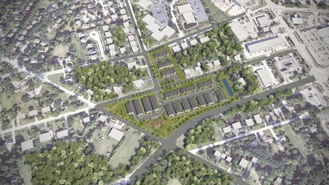 A bird's eye view of a residential area with a large green space in the center.