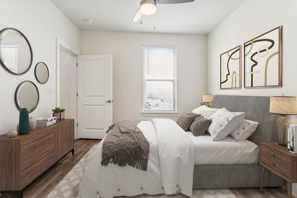 a bedroom with a bed with white sheets and pillows