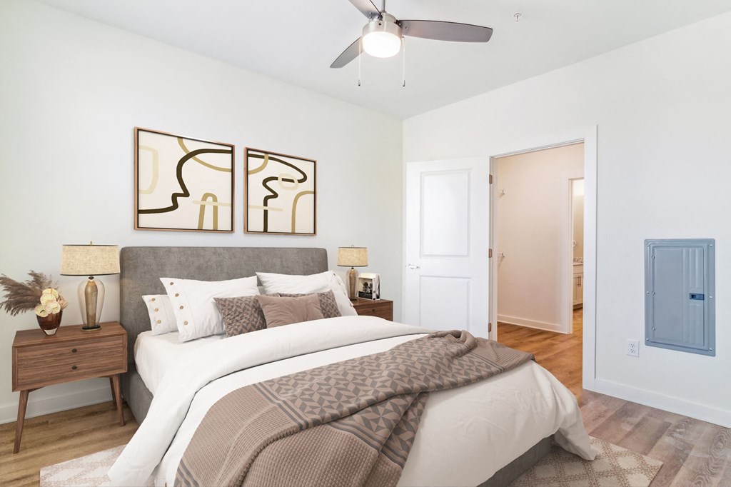 a bedroom with a large bed and a ceiling fan
