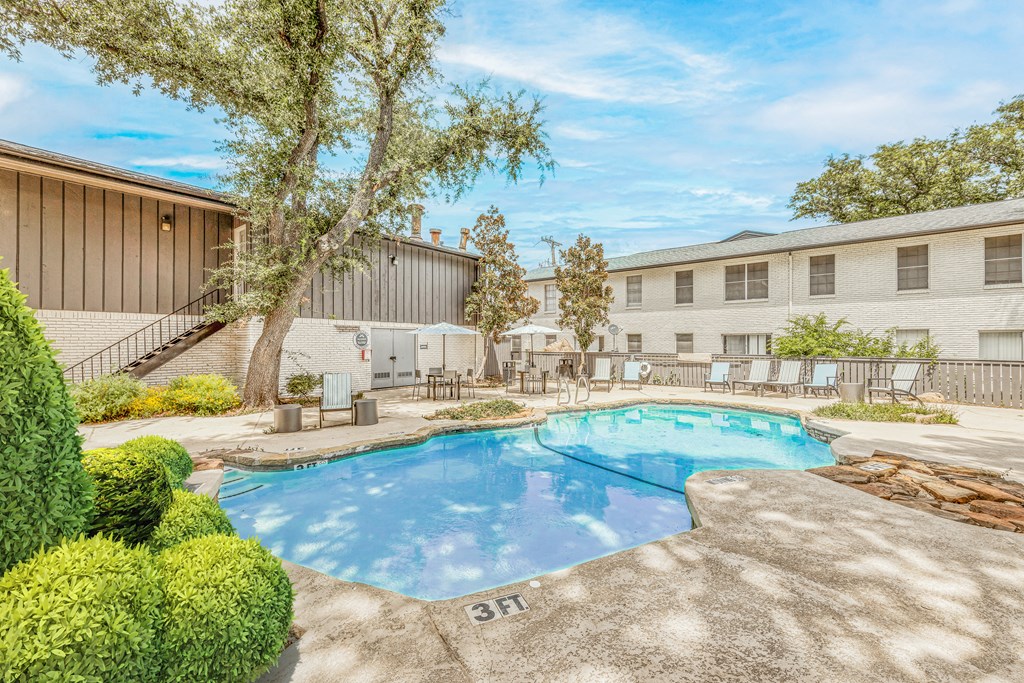 a swimming pool with a building in the background