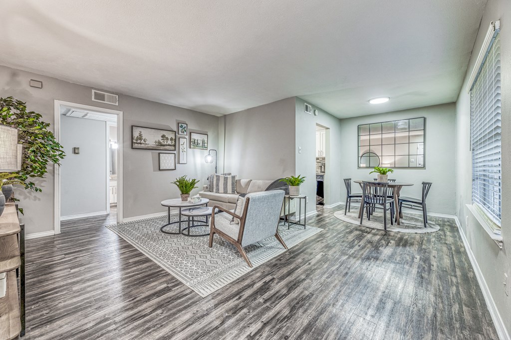 an open living room and dining room with a table and chairs