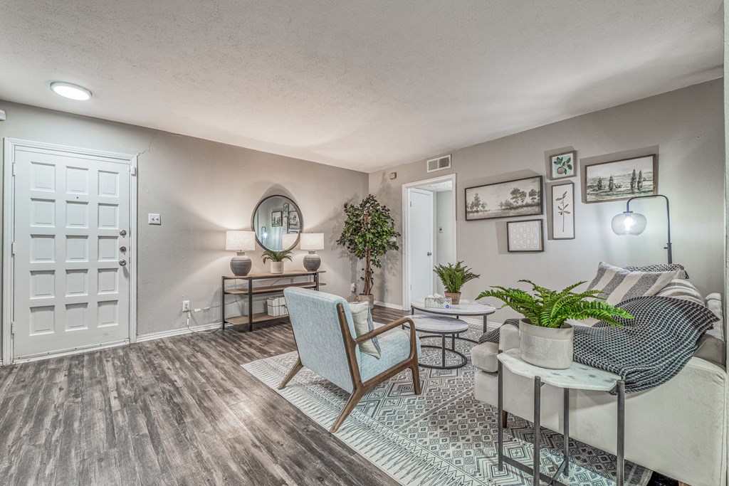 a living room with a couch and chairs and a table