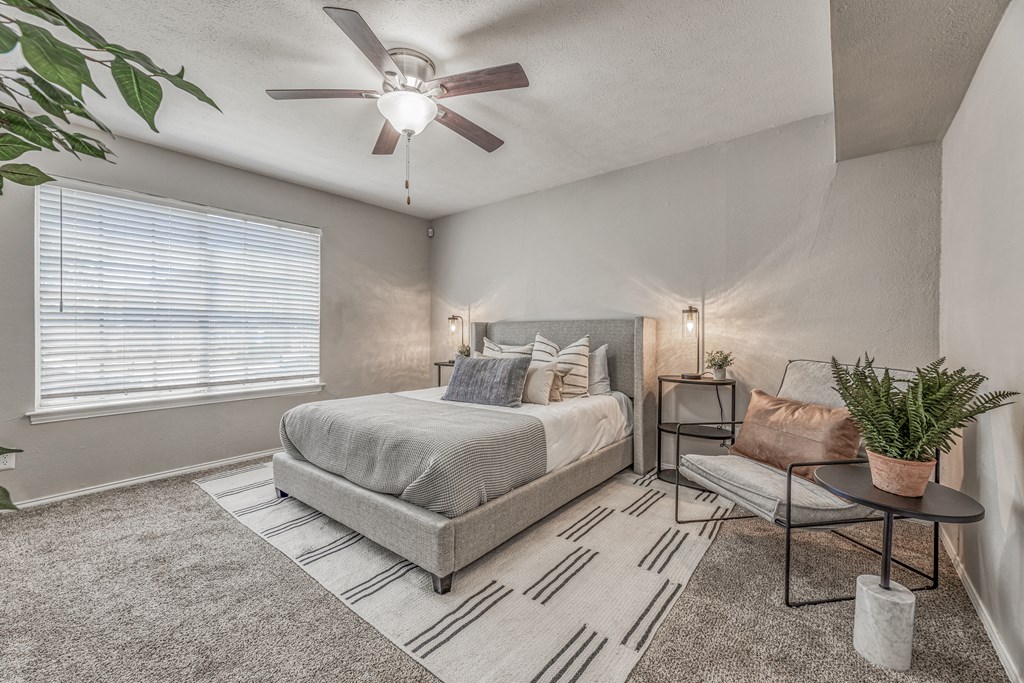 a bedroom with a bed and a ceiling fan