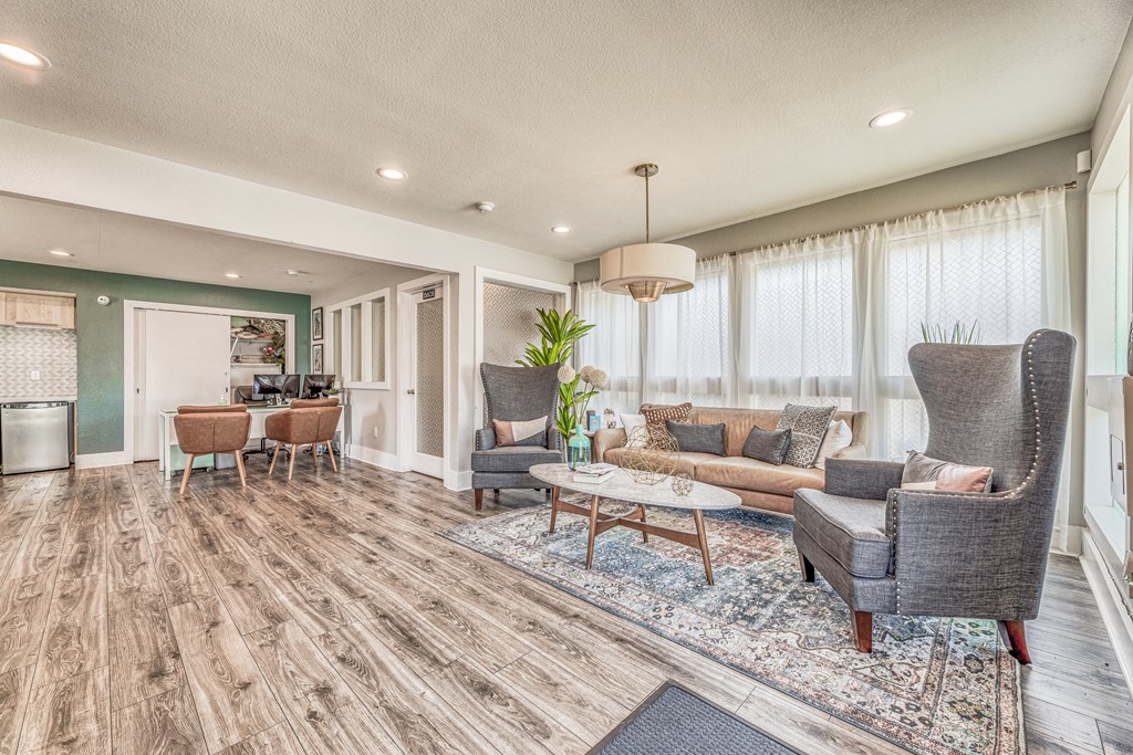 a living room with couches and chairs and a table