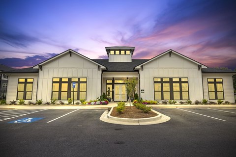the exterior of a church building with a parking lot