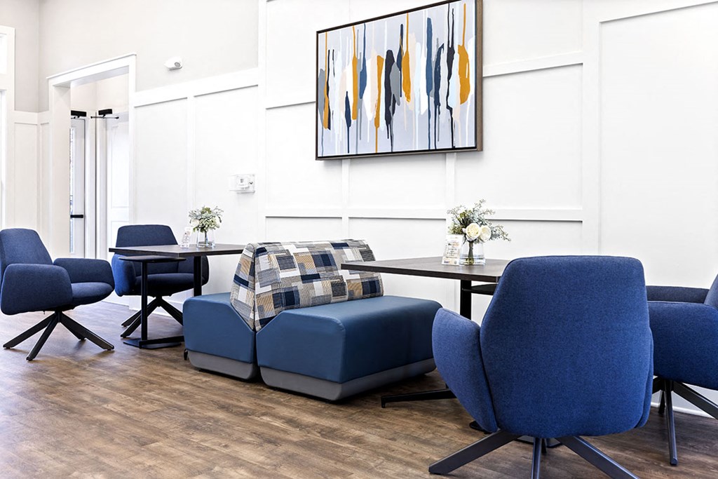 a living room with blue chairs and a table