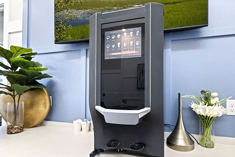 A modern bathroom with a black and white sink and a large painting on the wall.