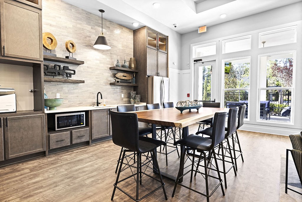 a large kitchen with a wooden table and chairs