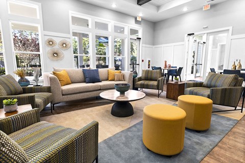 a living room with couches and chairs and a table