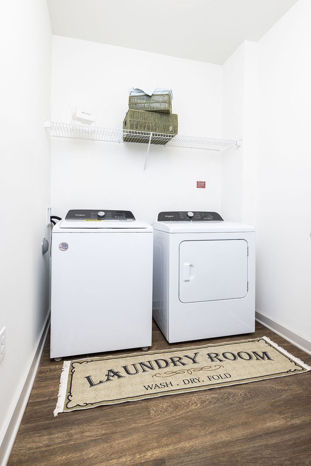 a washer and dryer in a laundry room with a rug