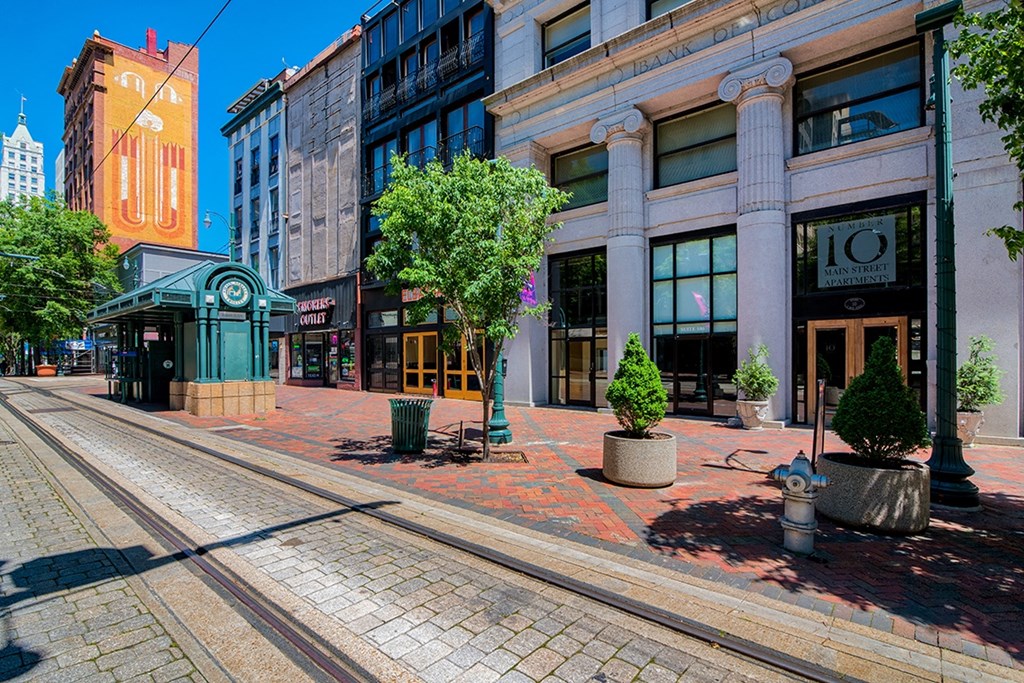 a city street with a train track in the middle of it