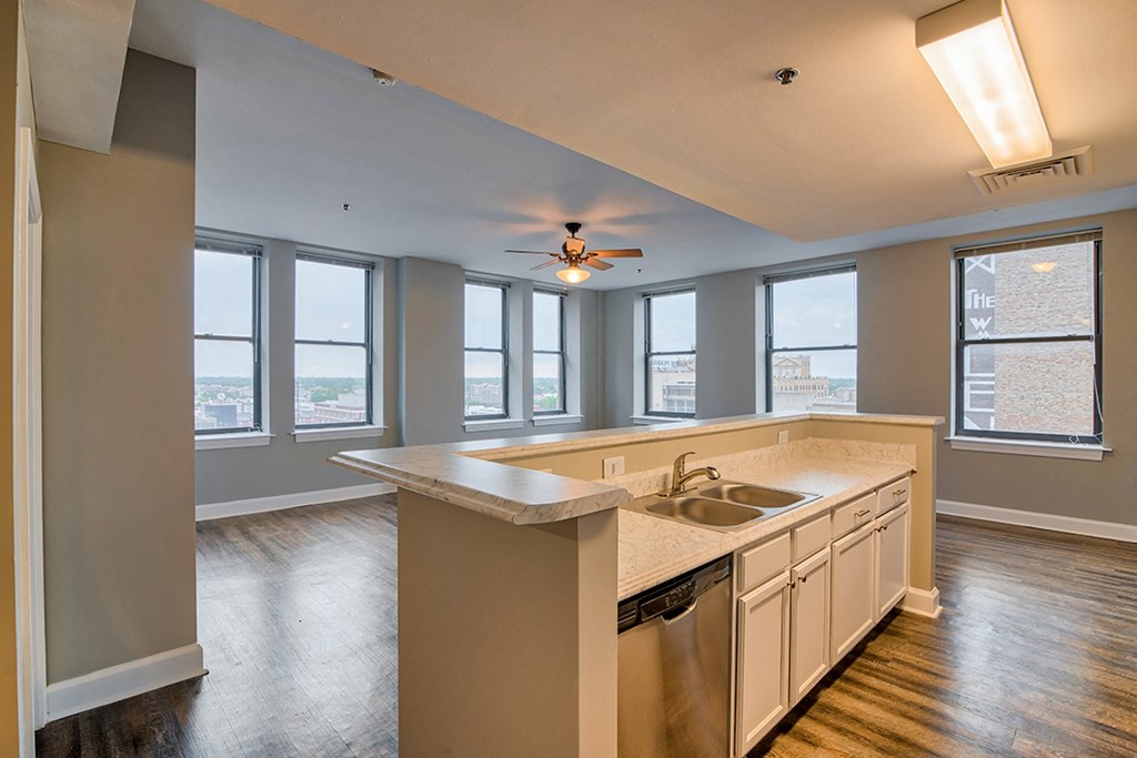 a kitchen with a large island and a ceiling fan