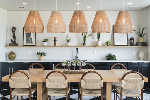 A dining room with a wooden table and chairs.