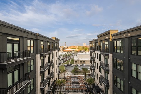 A view from the balcony of a building looking down at a courtyard.